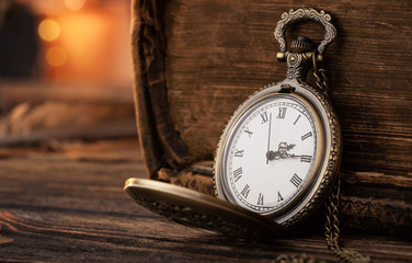 Old pocket watch on the wooden table with copy space