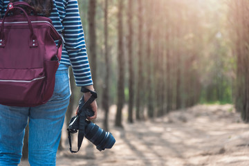 Fototapeta premium Young woman lifestyle using DSLR camera photographer travel taking photo