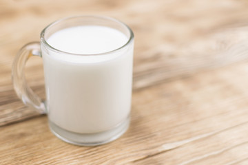 Glass kefir (milk) on a wooden background. The concept of diet, weight loss.