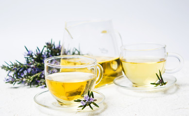 Rosemary tea with fresh plant and blossom