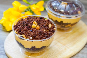 Lilac cake covered with chocolate and peanuts