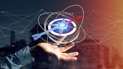 Business man holding a navigation compass - 3d rendered © Production Perig