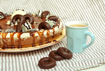 Homemade cake three chocolates with cup of coffee. Mousse glaze darkness decoration cake.