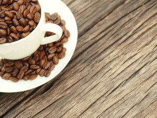 beans seed in cup of coffee on wooden table copy space