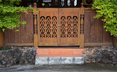 front view of entrance wood carved door, thai style