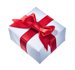 White wrapped present box with red knot isolated on white