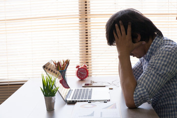 The man are stressed at work in the office. Asian businessman stressful and headache with laptop...