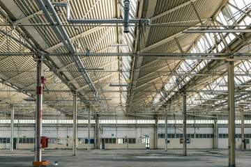 Abandoned industrial plant, interior. Spoiled and ruined industrial hall details, financial crisis, loss of employment.