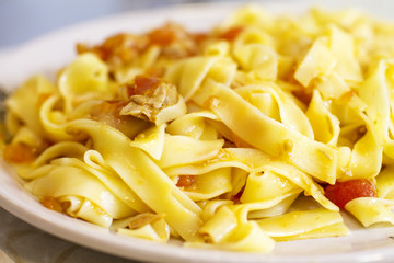 Fettuccine dish with tomato tuna sauce, food close up