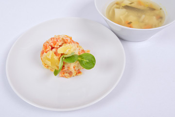 Cream potatoes with vegetables on a white