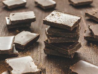 Dark chocolate stack on wooden background