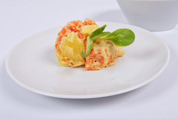 Cream potatoes with vegetables on a white