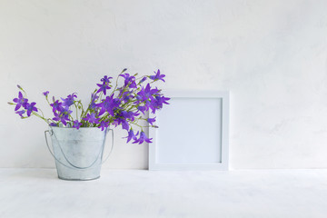 Mockup with a white frame and summer flowers