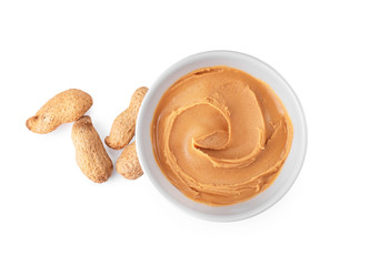 Bowl with creamy peanut butter on white background