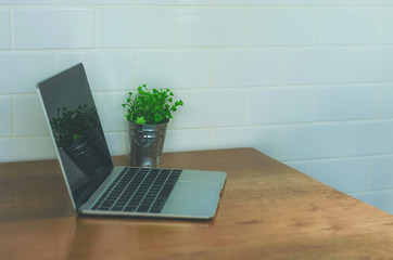 empty computer laptop with highlight pen on table in coffee shop with copy space. freelance concept, still holiday concept, relax working concept. digital technology.