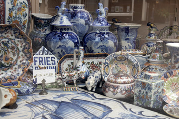 Showcases of Dutch shops with blue typical dishes and skulls