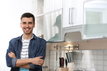 Portrait of handsome young man in kitchen