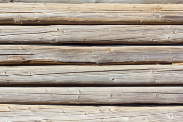 Obraz premium background of logs, old wooden log cabin with a crevice, the old rustic wall of the hut,