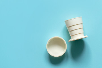 old vintage plastic folding glass on a blue background