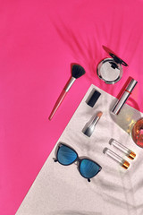 Naklejka premium Woman's accessories lying flat on textured paper background. Pink and white colors with copy space around products.