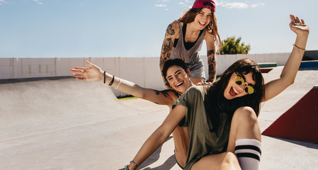 Women at skate park having fun with skateboard