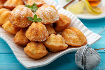 Madeleine - homemade traditional French small cookie on light blue background.