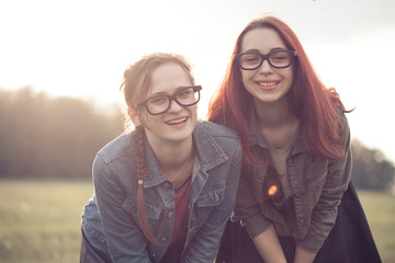 Two young girls resting outdoors. The best friends