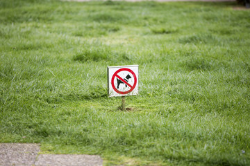 Dogs forbidden sign on grass in Rovinj, Croatia