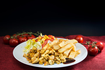Fresh chicken steak with tomatoes and french fries