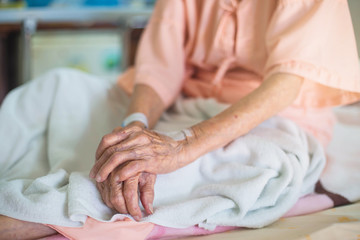 medicine, age, health care and people concept - older woman patient lying in bed at hospital ward.