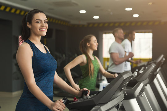 Fitness people training in gym on treadmills