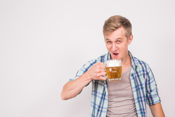 joyful man with a beard with a mug of beer on a blue background, alcohol