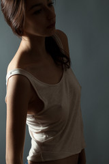 Naklejka premium Attractive thin young woman in studio. Low key