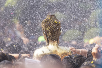 Buddha statues ,Gold buddha, Songkran Festival, People come to bathing the statue of Luang Pho Phra Sai With respect to faith at Wat Pochai Temple, Nong Khai, Thailand