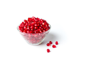 Pomegranate fruits in a bowl on white background