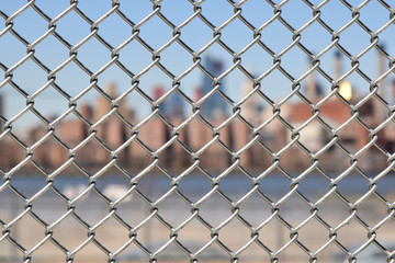 Fototapeta premium Urban chain link fence closeup abstract texture background. 
