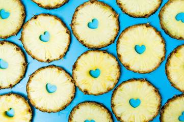 Pineapple slices on blue background flat lay