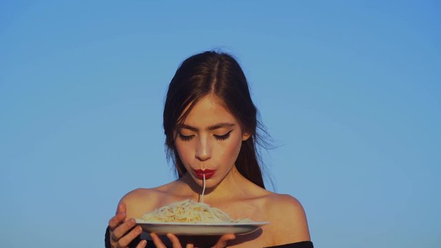 Italian macaroni or spaghetti for dinner, cook. italian food and cuisine. Woman eating pasta as taster or restaurant critic. woman with italian pasta and tea or coffee.