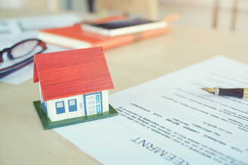 Mortgage contract for sale of contract house with paper and vintage tone.