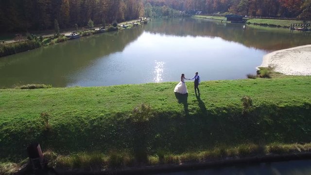 wedding dance. wedding day. newlyweds are dancing on the waterfront. bride and groom dance near the picturesque blue lake