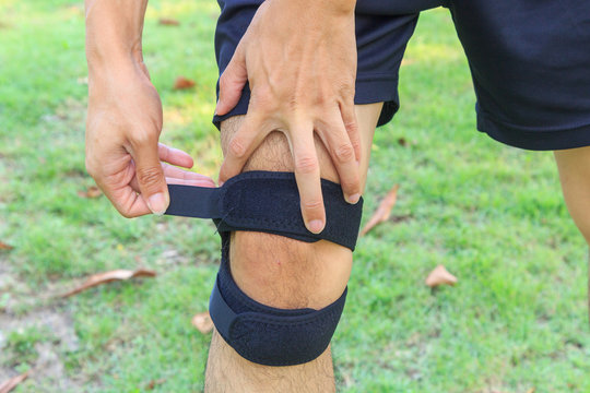 The Man Wear Knee Support With Sunlight In The Park / Brace Knee Pads Leg 