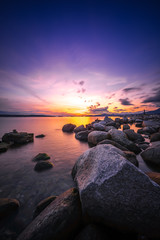 Fototapeta na wymiar Rocks beach with sunset sky backgrounds