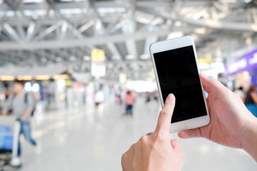 Cropped shot of hands traveler using smartphone mobile in the airport terminal