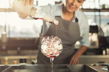 Experienced barista making alcohol cocktail in cafe