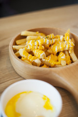 Close-up shot of delicious melted cheese fries, specially prepared and served by a cafe