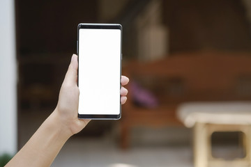 Hands showing mockup smartphone mobile with white screen.