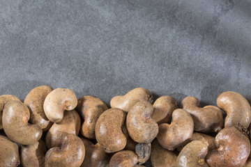 Fototapeta na wymiar Cashew nut on wooden background - Anacardium occidentale