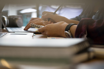 Cropped shot of writing with hand on paper.