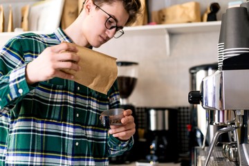 Barista prepares black coffee in the kitchen