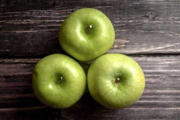 Green apples on a wood board